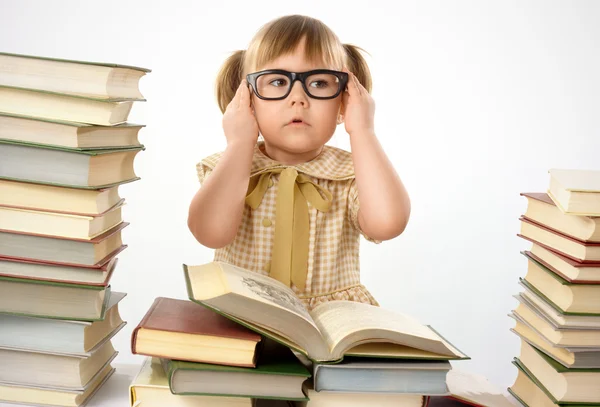 Little girl with books wearing glasses — Stock Photo, Image
