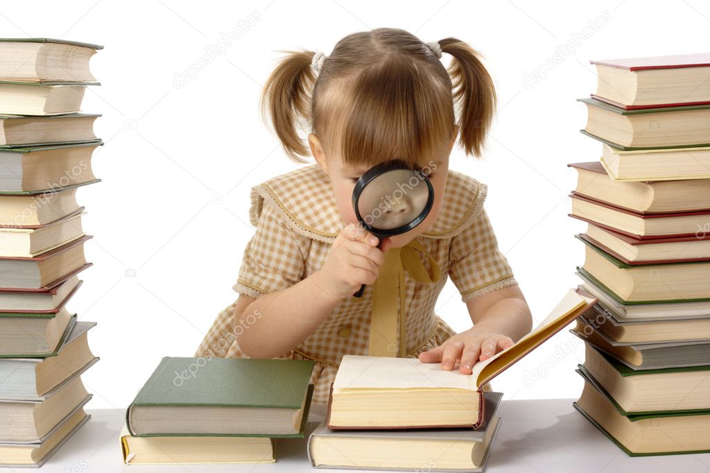 Little girl looking at book
