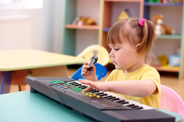 stock image Girl with electronic piano and microphone