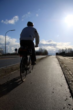 Cyclists to work in the morning sun clipart