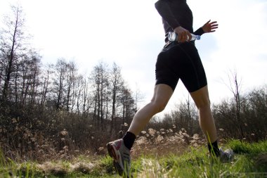 Young woman running in the grass clipart