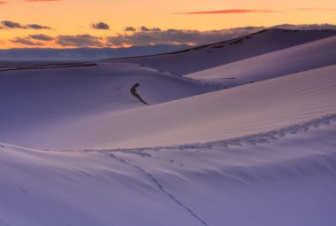 Winter sunset over the dunes clipart