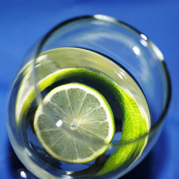 Glass with water and lime — Stock Photo, Image