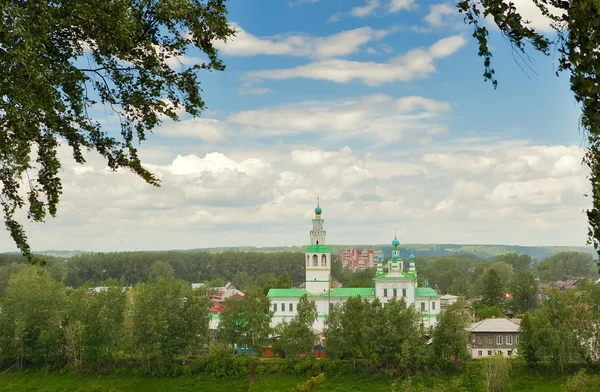 Orthodoxe kerk omlijst door filialen onder de wolken — Stockfoto