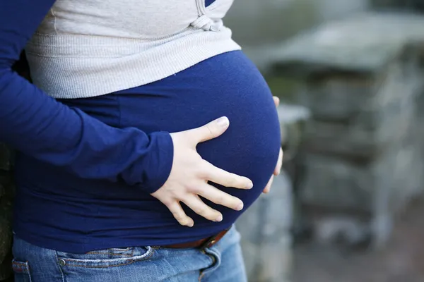 Primer plano de la barriga embarazada de la mujer . — Foto de Stock