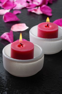 Candle and flower petal decoration. clipart