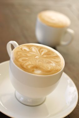 Delicious latte with coffee art design. clipart