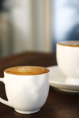 Two delicious lattes on a table. clipart