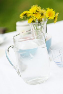 Jug of water and glasses on a table.