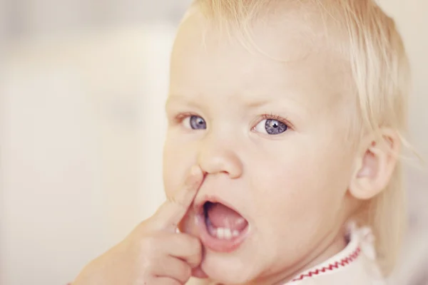 Cute little girl pointing at her nose. — Stock Photo, Image