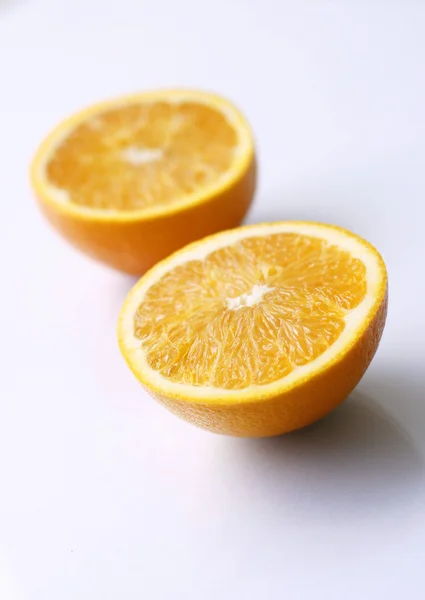 Две оранжевые половинки на светлой поверхности . — стоковое фото