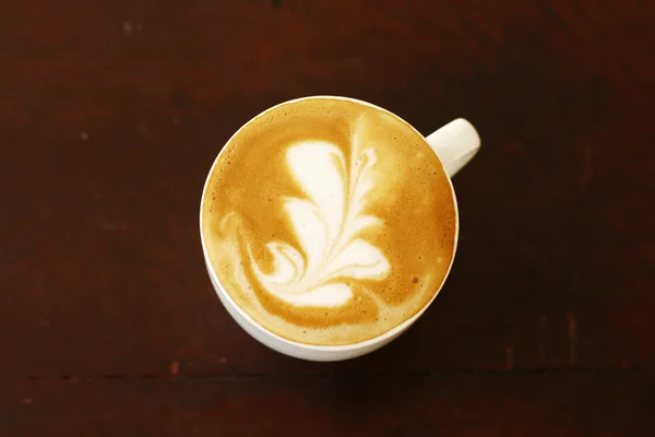 Bovenaanzicht van piccolo latte met een kopje koffie — Stockfoto