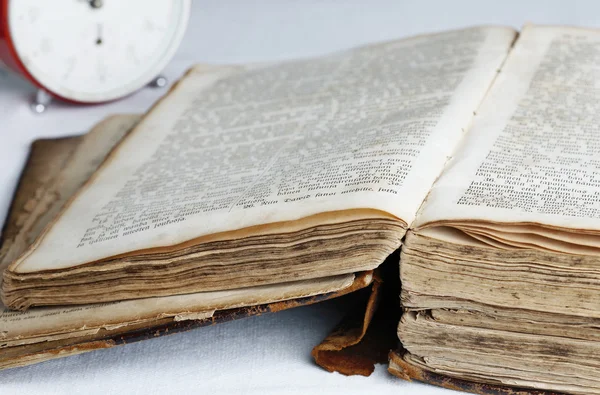 stock image Old book and analog clock.