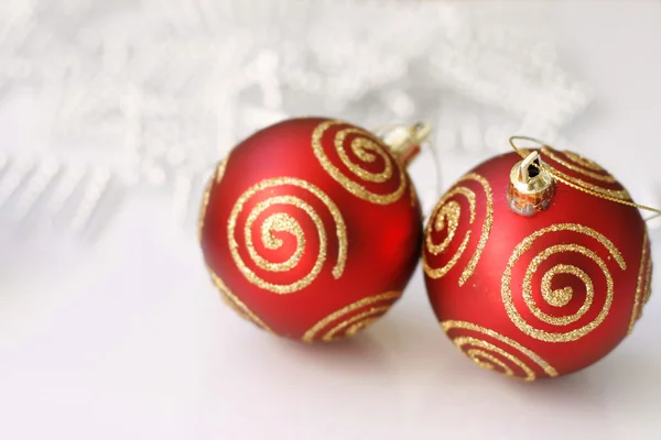 Red Christmas baubles on a glass table. — Stock Photo, Image