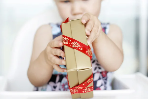 Menina cuidadosamente abrindo o Natal — Fotografia de Stock