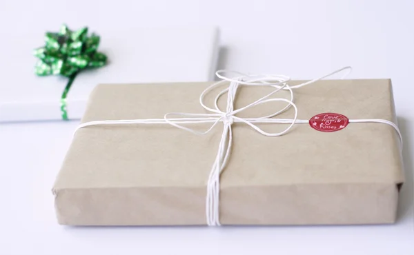 Two simply wrapped gifts with decoration — Stock Photo, Image