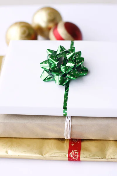 Three simply wrapped Christmas gifts wit — Stock Photo, Image