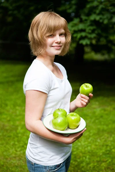 Girl holding fresh green apples — Stock Photo, Image