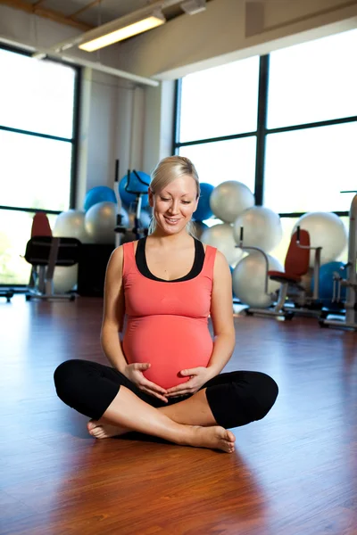 Schwangere entspannt sich und hält Bauch. — Stockfoto