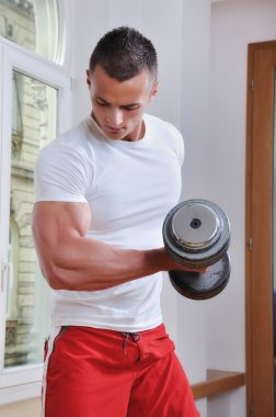 Powerful muscular man lifting weights clipart