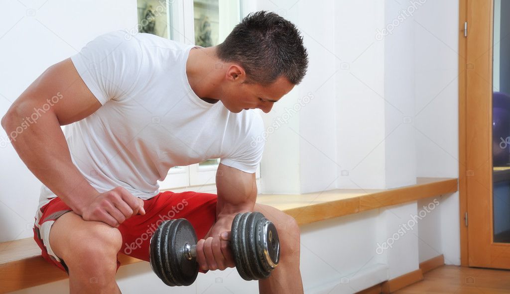 Powerful muscular man lifting weights