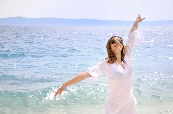 stock image Beautiful young woman on the beach