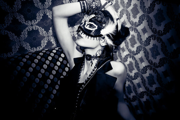 Beautiful woman with mask in night club