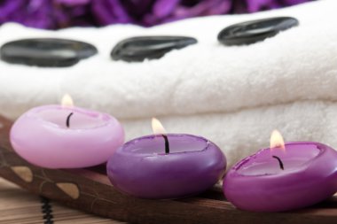 Hotstones on towel with candles (2) clipart