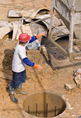 Construction worker assisting pourer (1) clipart