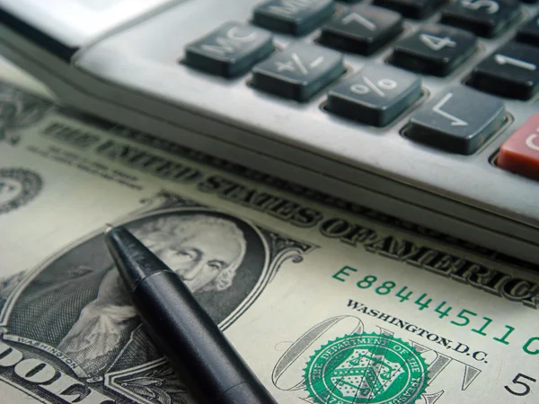 stock image Dollar bill,calculator and pen