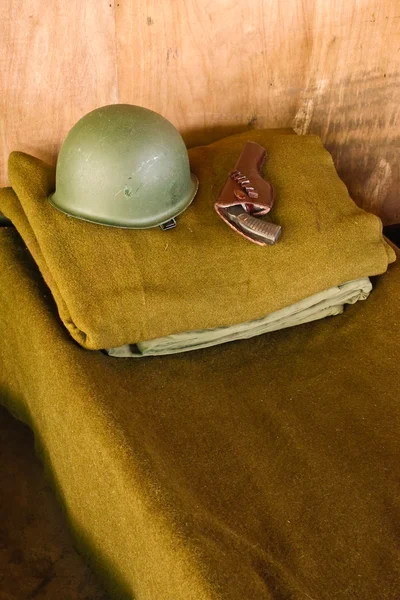 stock image Military bed with helmet and pistol