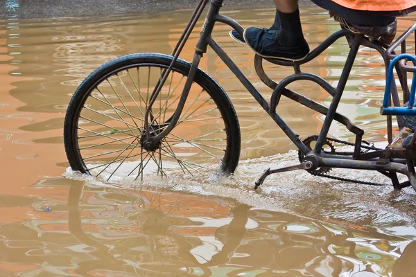 stock image Bike riding through flooded streets