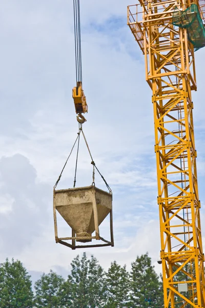 Concrete pourer hanging from crane — Stock Photo, Image