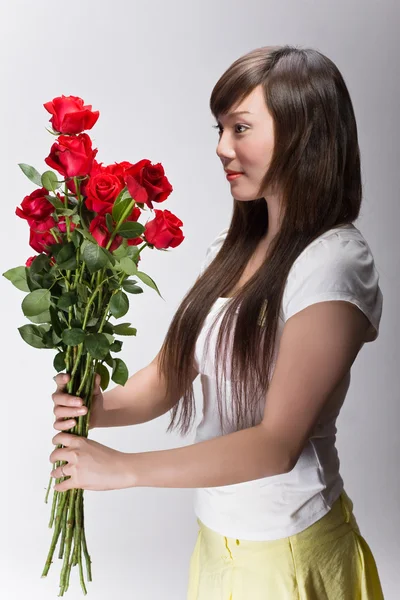 Cute asian girl accepting flowers — Stock Photo, Image