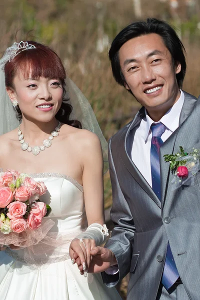 stock image Attractive bride and groom holding hands