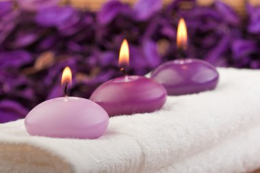 Purple candles on massage towel (1) clipart