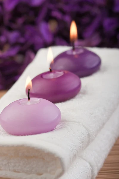 Purple candles on massage towel (2) Royalty Free Stock Images