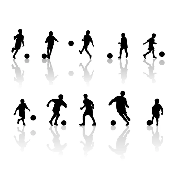 Piccoli giocatori di calcio silhouette — Vettoriale Stock