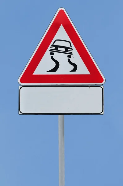 Försiktighet slippery road — Stockfoto