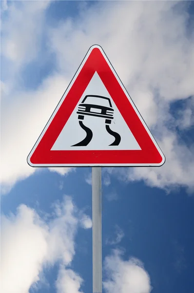 Försiktighet slippery road — Stockfoto