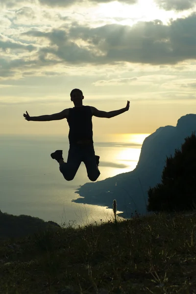 stock image Jumping man on the sunset.