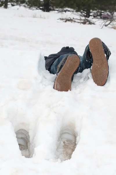 stock image The guy lies in snow