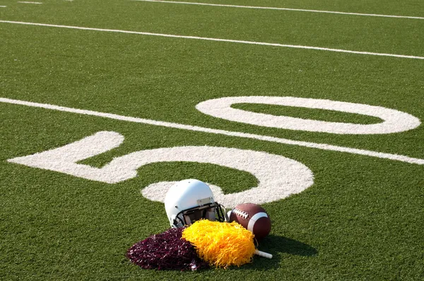 American Football Equipment and Pom Poms on Field — Stock Photo, Image
