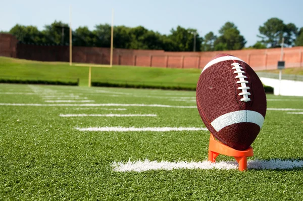 Closeup of American Football on Tee on Field — Stock Photo, Image