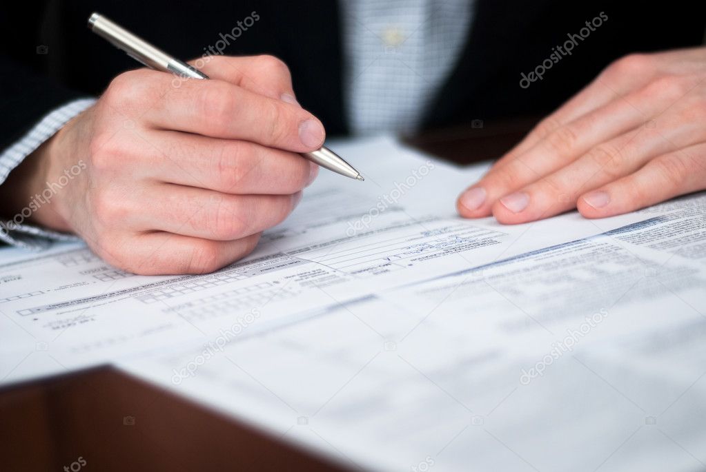 Filling out documents on a desk.