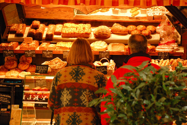 The family doing shopping at the bakery.