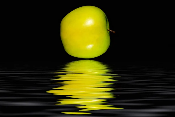 Green apple on a black background — Stock Photo, Image