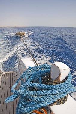 Stern of a motor yacht with a wake clipart