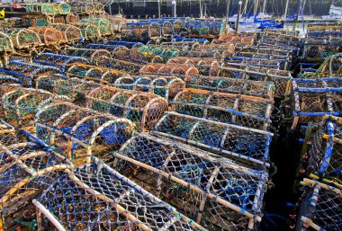 Lobster pots on a quayside clipart