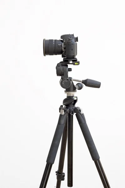 stock image Digital SLR camera on a tripod on white